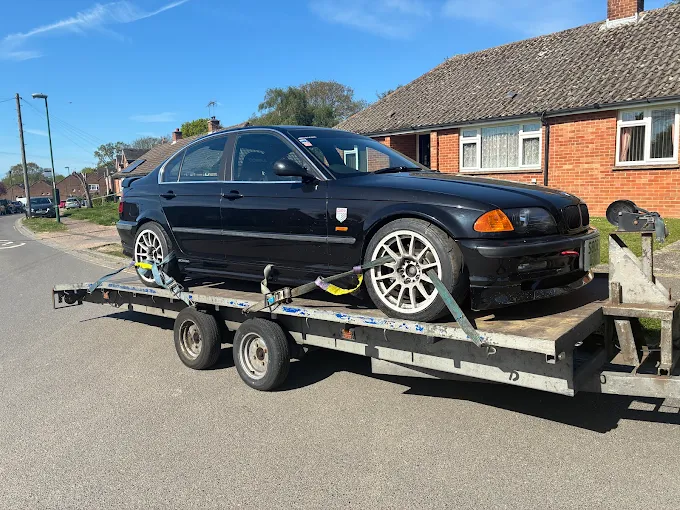 Saloon car transported on a trailer