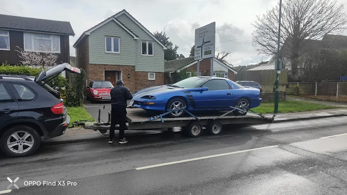 Cars collected for transport in a residential street