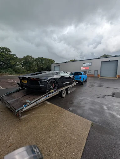 Formula race car loaded on a flatbed transporter
